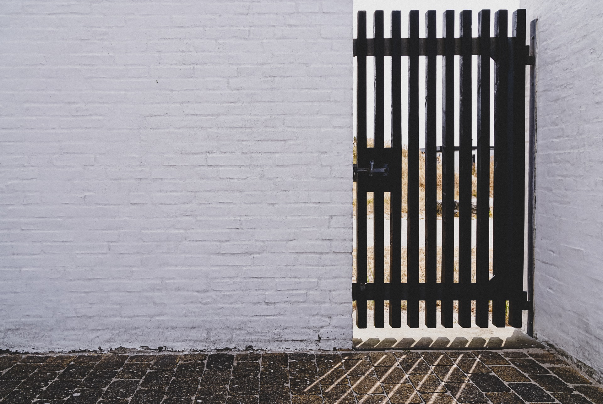 Photo of wall and gate by Henning Kesselhut on Unsplash
