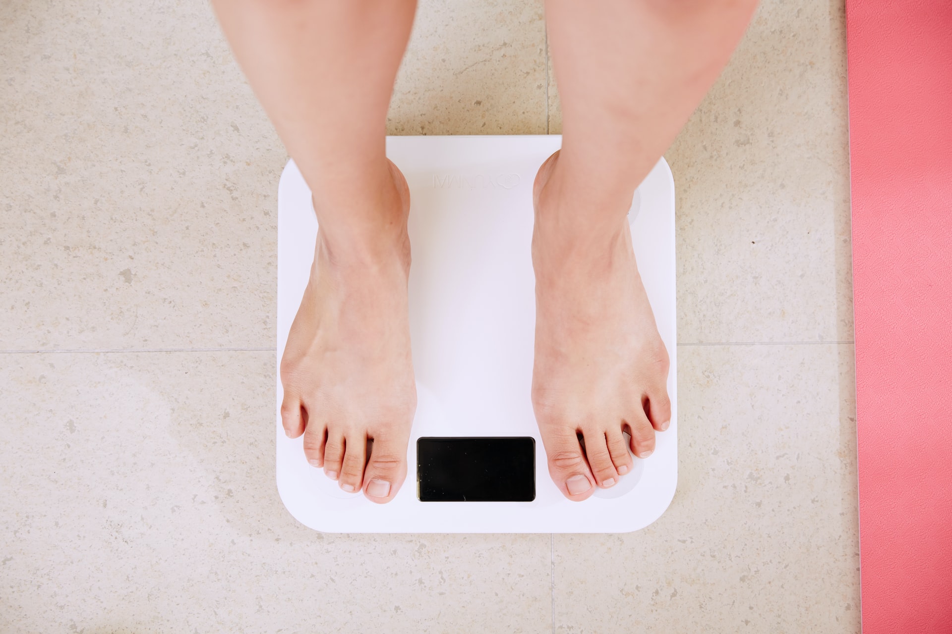 Photo of someone weighing themselves by i yunmai on Unsplash
